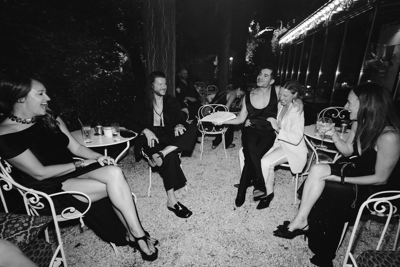 guests and groom chatting in the garden during party time at this gay wedding at Hotel Particulier Montmartre, Paris