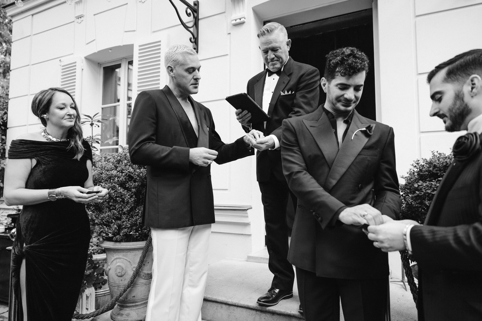the grooms get ready to exchange rings at this gay wedding in the garden of Hotel Particulier Montmartre, Paris