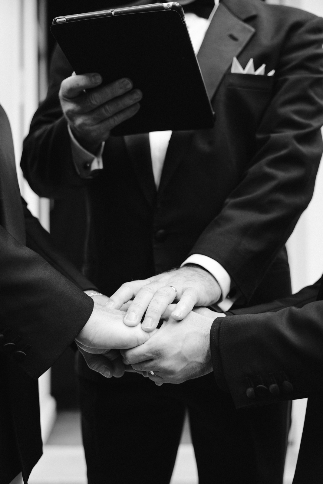close up on the groom's dad's hand blessing the union of his son and husband at this gay wedding in the garden of Hotel Particulier Montmartre, Paris