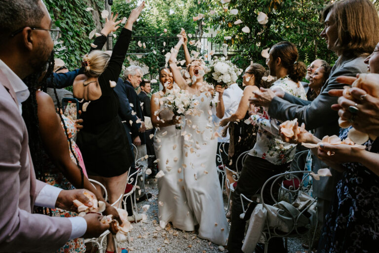 brides hooze with happiness as they exit their garden ceremony in Montmartre, Paris