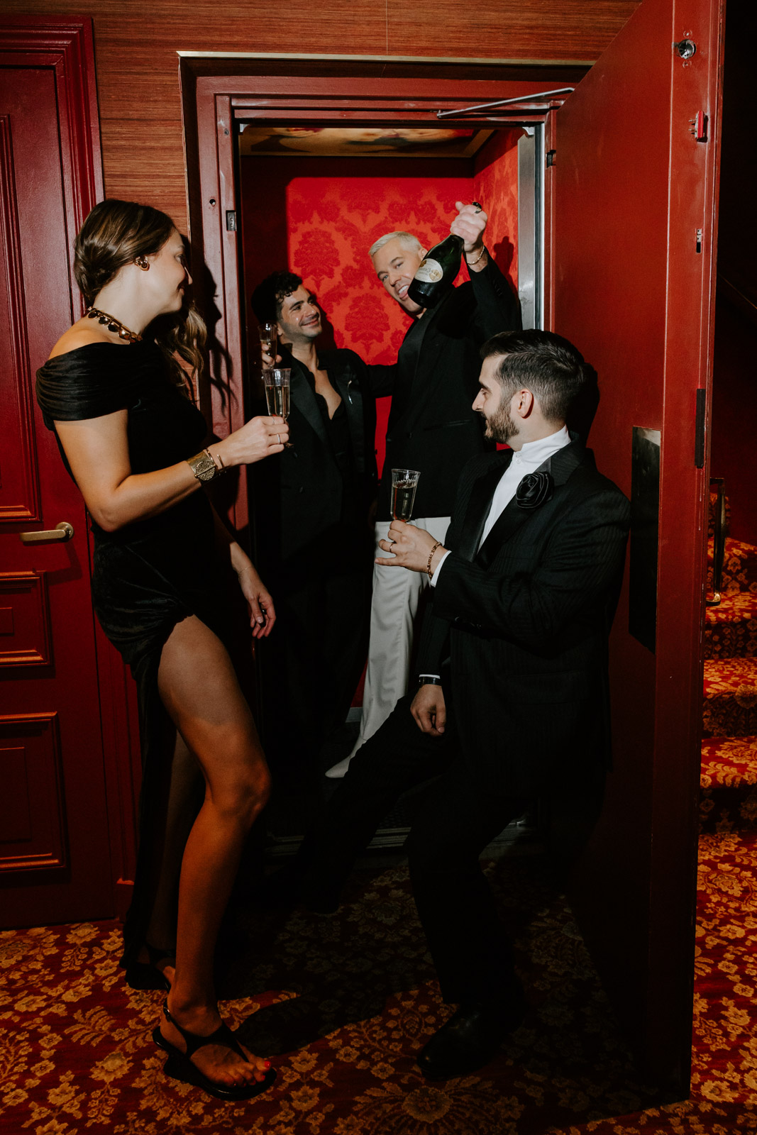 Vogue-style wedding group shot in elevator of Hotel Particulier Montmartre.