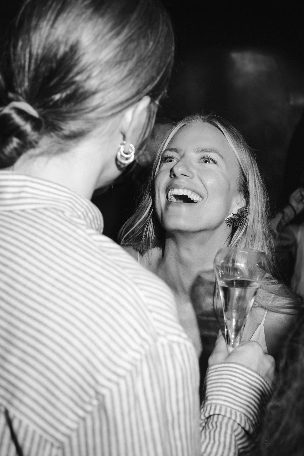 guest laugh at this wedding's welcome dinner at Le Georges, on the rooftop of Pompidou Centre in Paris
